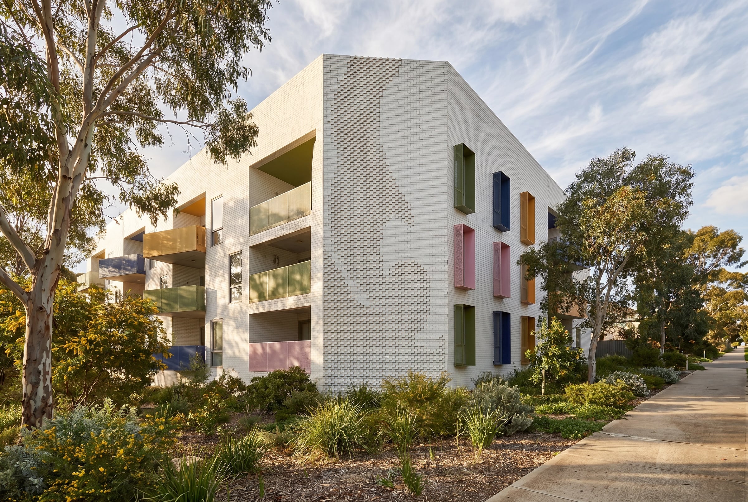 Render showing the brick relief wrapping the corner beside colourful hooded windows in East Fremantle.